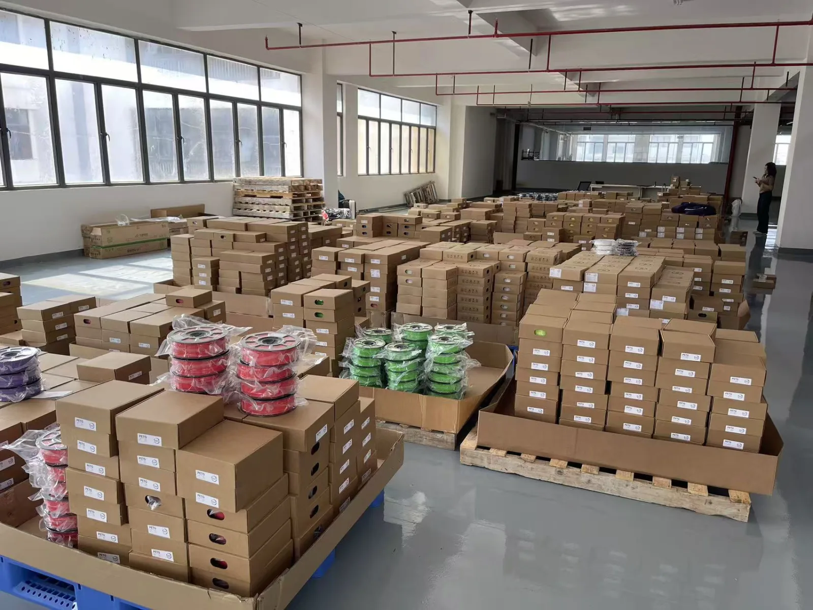 Bagged coloured filament spools and labelled cardboard boxes at Sungallon’s packing area
